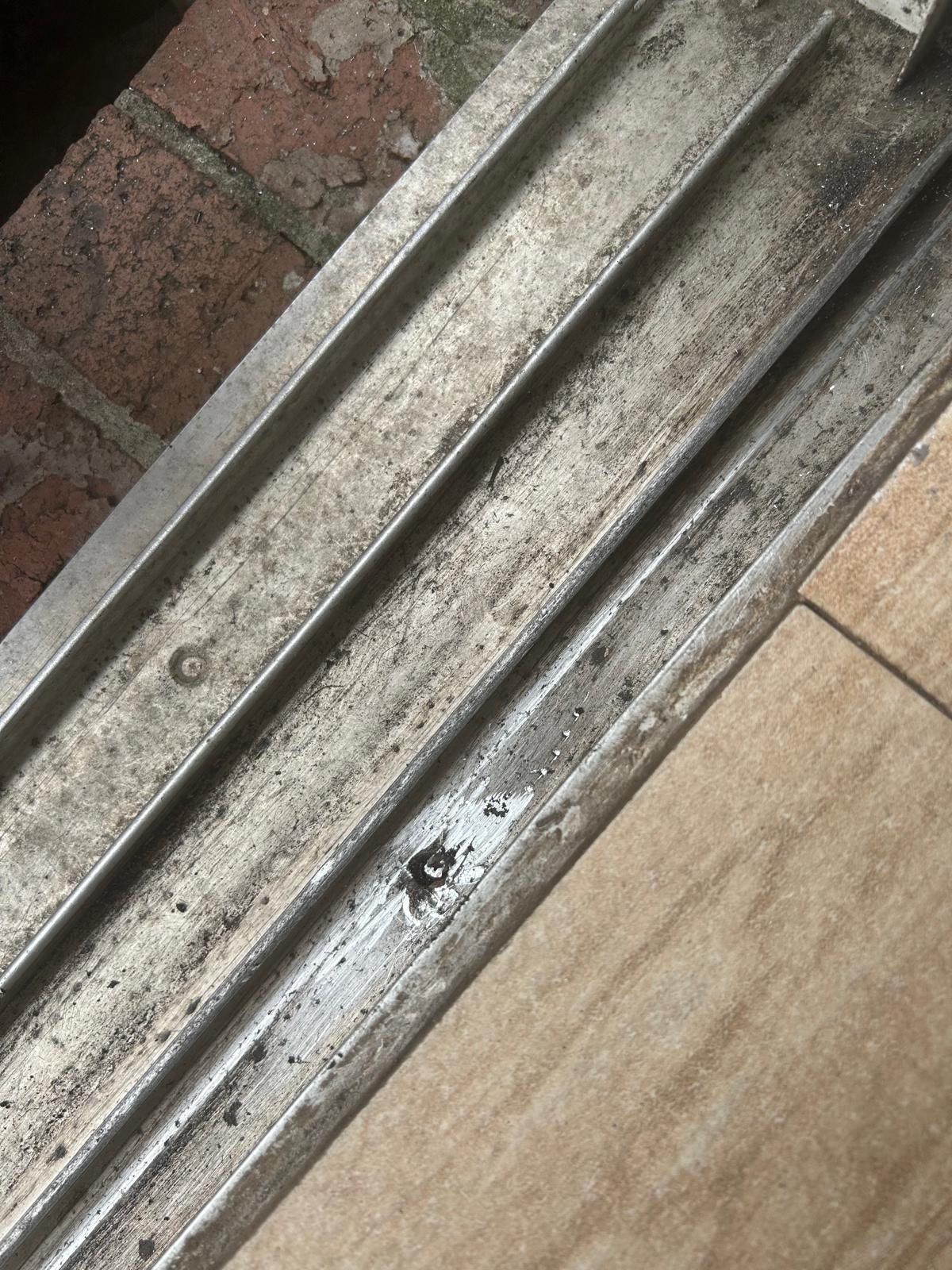 Years of metal-on-metal wear cut a groove into this aluminum track.